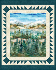 Quilt with a scenic landscape of a lake and forest framed by decorative border
